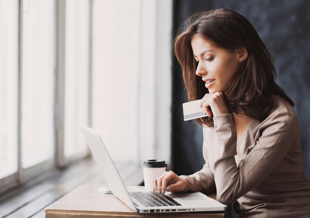 woman entering credit card information in online checkout.